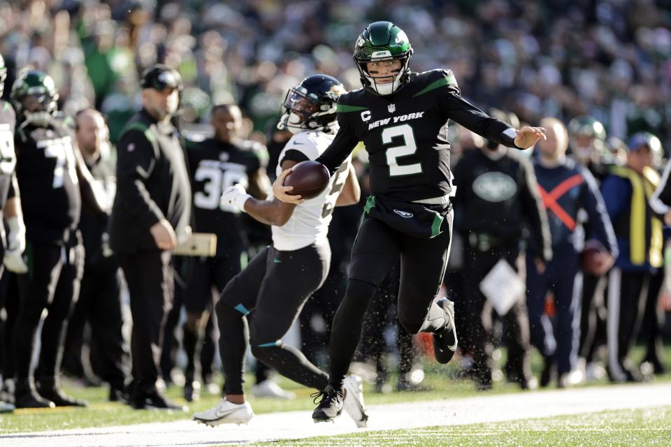 New York Jets quarterback Zach Wilson (2) rushes for a touchdown during an NFL football game against the Jacksonville Jaguars on Sunday, Dec. 26, 2021, in East Rutherford, N.J. (AP Photo/Adam Hunger)