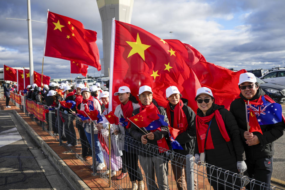 Supporters of Chinese Premier Li Qiang wait on his arrival at Adelaide Airport, Australia, Saturday, June 15, 2024. Li is on a relations-mending mission with panda diplomacy, rock lobsters and China's global dominance in the critical minerals sector high on the agenda during his four day visit to Australia. (Asanka Brendon Ratnayake/Pool Photo via AP)