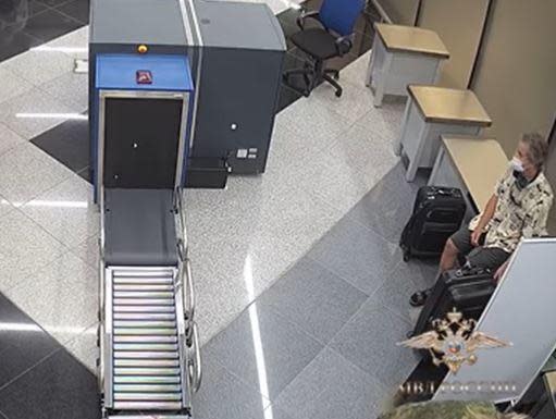 A screengrab from video released by Russia's Interior Ministry shows U.S. national Marc Fogel sitting in a security screening area at Moscow's Sheremetyevo airport, where he was detained in August 2021 after marijuana was allegedly found in his luggage. / Credit: Russian Interior Ministry/Handout