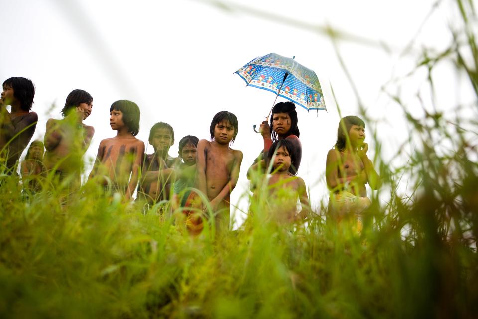 Miembros de la comunidad Kraho permanecen juntos bajo la lluvia. (Jeff Hutchens/Getty Images)