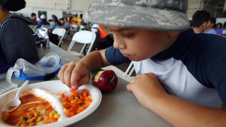 Matteo Christiansen, 9, reaches for his vegetables, after finishing his meatball sub and working on his apple at Shake-A-Leg’s summer camp in Coconut Grove in July 2017.