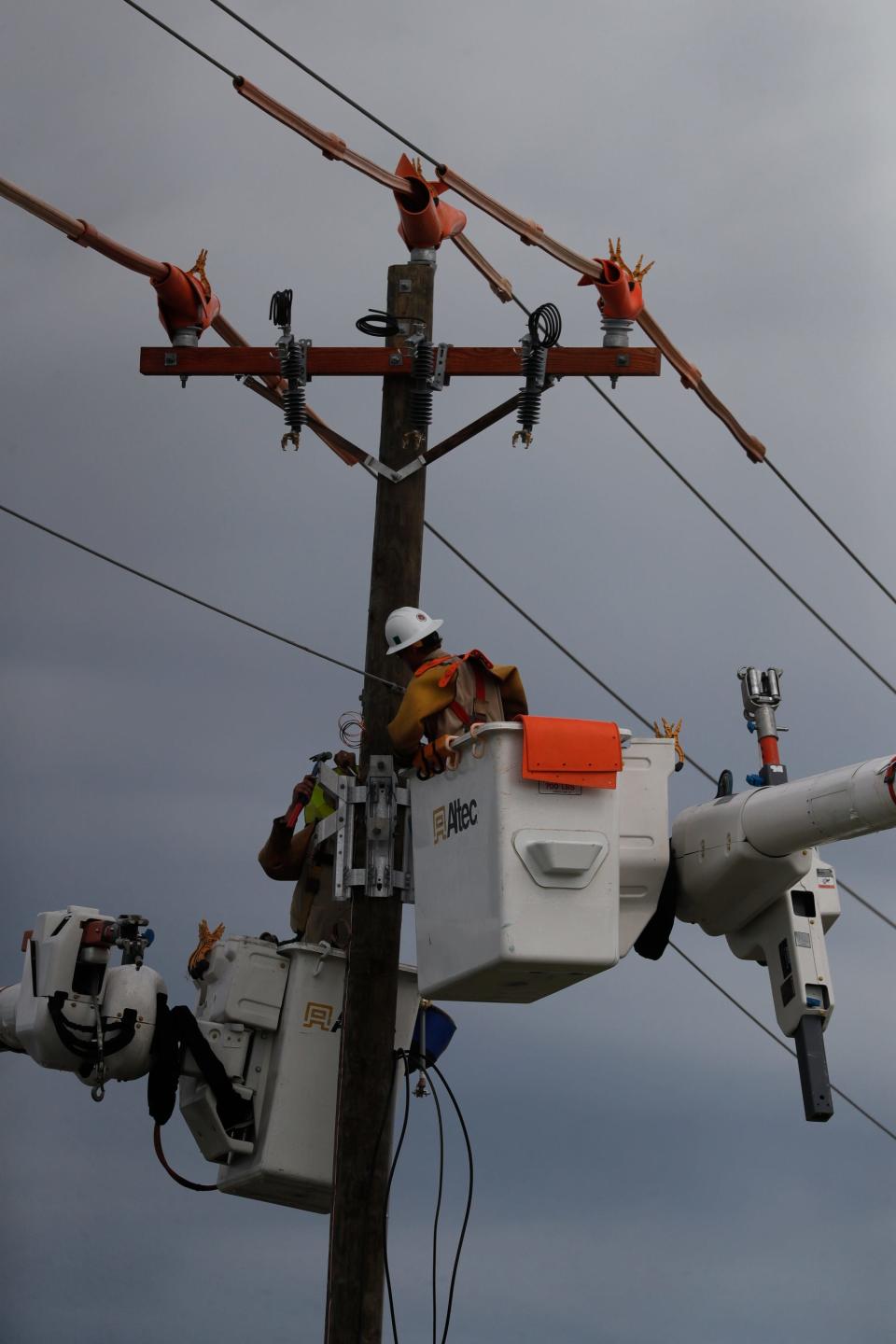 Line crews work along Agualinda Blvd. to restore power to area residents in Cape Coral Sunday, October 9, 2022. Many people struggled without power at their homes after impact from Hurricane Ian.
