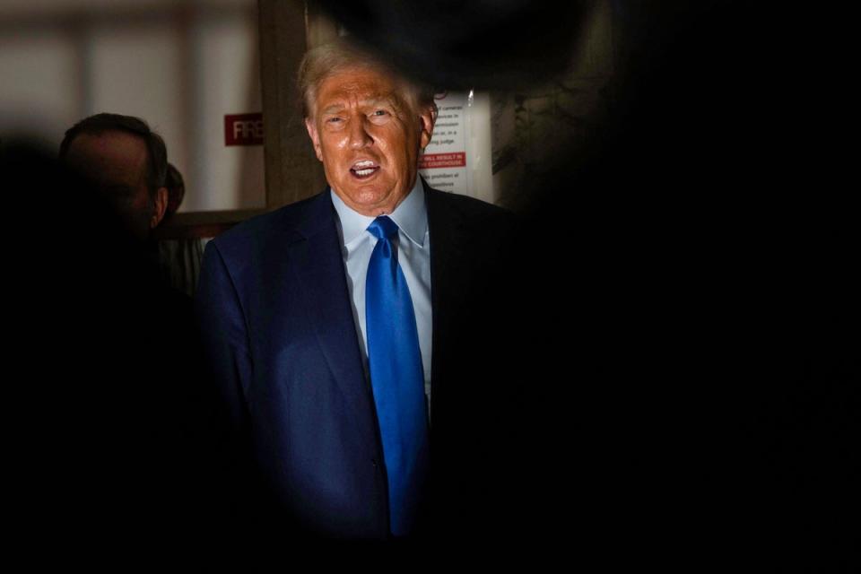 Donald Trump talks to reporters outside Judge Arthur Engoron’s courtroom in New York Supreme Court on 24 October. (AFP via Getty Images)