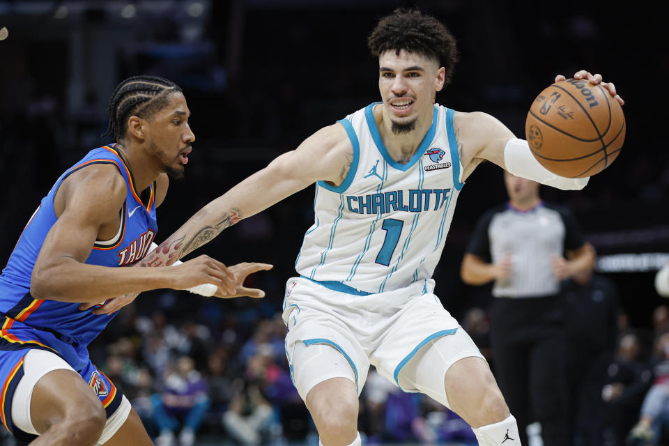 Oct 15, 2023; Charlotte, North Carolina, USA; Charlotte Hornets guard LaMelo Ball (1) drives into Oklahoma City Thunder guard Aaron Wiggins (21) in the second half at Spectrum Center. Mandatory Credit: Nell Redmond-USA TODAY Sports