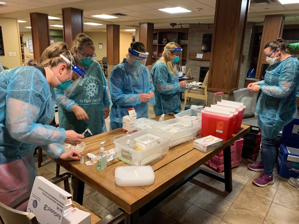 Health care workers in North Dakota prepare COVID-19 vaccines for a clinic Feb. 26.