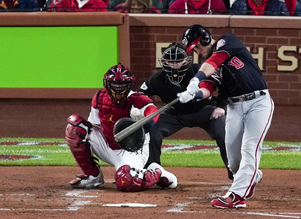 Washington Nationals' Yan Gomes hits an RBI double during the second inning of Game 1 of the baseball National League Championship Series against the St. Louis Cardinals Friday, Oct. 11, 2019, in St. Louis. (AP Photo/Charlie Riedel)