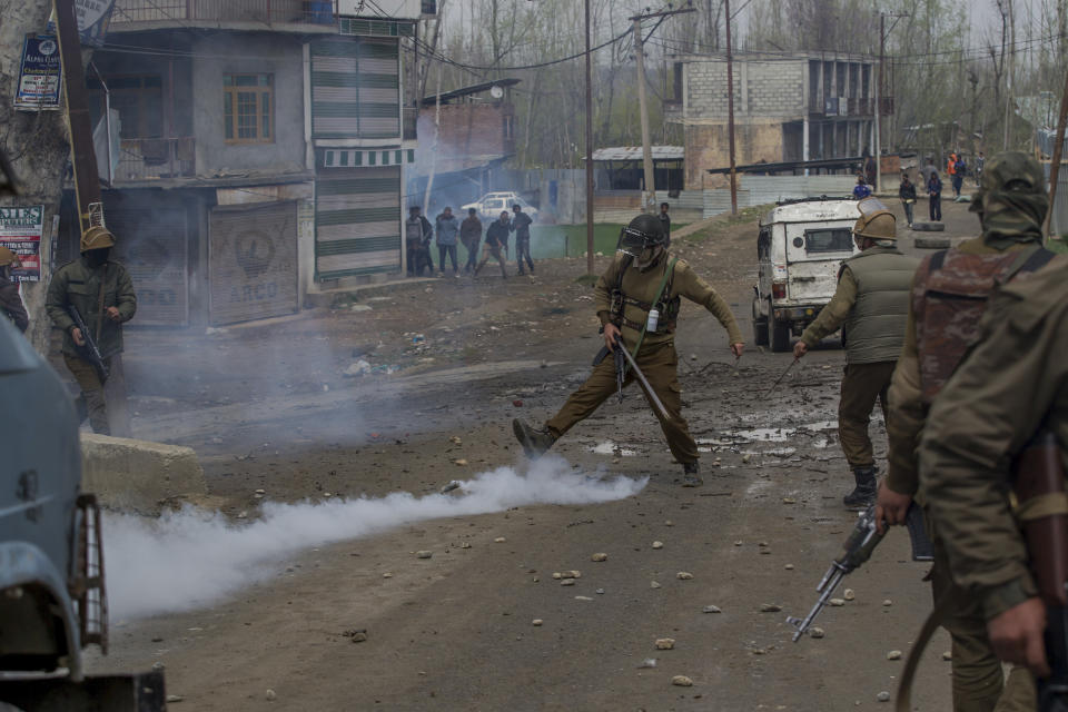 An Indian policeman kicks an exploded tear gas shell during a protest near the site of a gun battle in Chadoora town, about 25 kilometers (15 miles) south of Srinagar, Indian controlled Kashmir, Tuesday, March 28, 2017. Three civilians were killed and 28 other people were injured in anti-India protests that erupted Tuesday following a gunbattle between rebels and government forces that killed a rebel in disputed Kashmir, police and witnesses said. The gunbattle began after police and soldiers cordoned off the southern town of Chadoora following a tip that at least one militant was hiding in a house, said Inspector-General Syed Javaid Mujtaba Gillani. As the fighting raged, hundreds of residents chanting anti-India slogans marched near the area in an attempt to help the trapped rebel escape. (AP Photo/Dar Yasin)