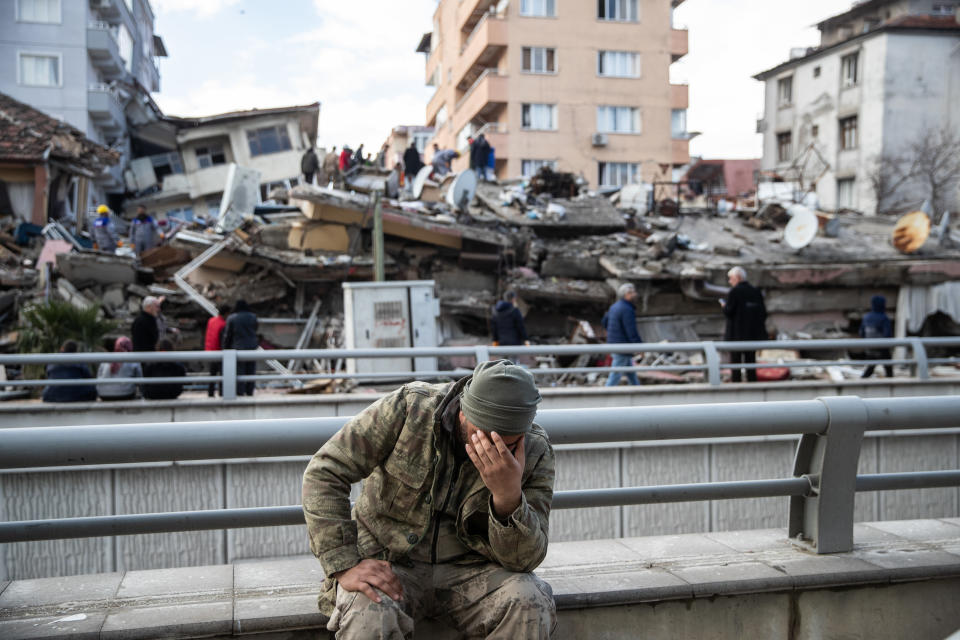 A soldier grieves near a collapsed building in Gaziantep, Turkey.