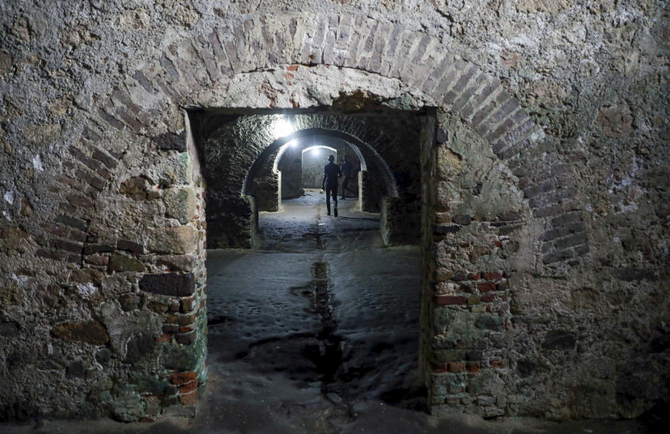 Visitors walk though dungeons used to house female slaves at the Cape Coast Castle, one of several slave forts build along the Gold Coast in Ghana. (Photo: Siphiwe Sibeko/Reuters)