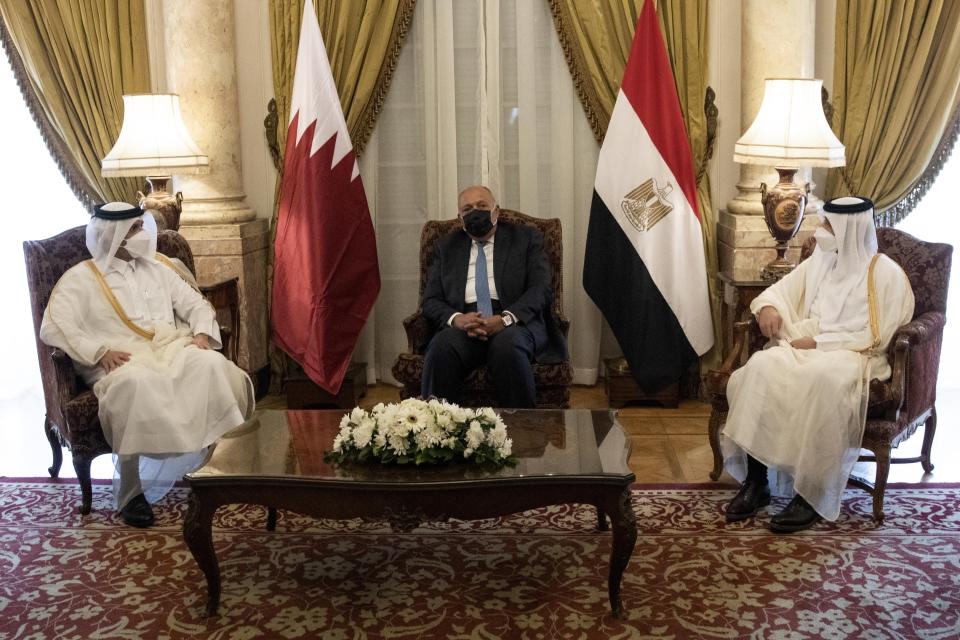 Qatar's Deputy Prime Minister and Foreign Minister Sheikh Mohammed bin Abdulrahman bin Jassim Al-Thani, left, meets with Egyptian Foreign Minister Sameh Shoukry, center, at the Tahrir Palace in Cairo, Egypt, Tuesday, May 25, 2021. (AP Photo/Nariman El-Mofty)