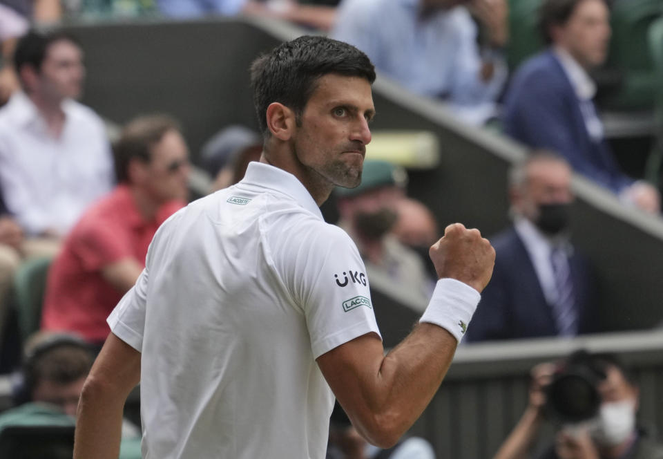 Serbia's Novak Djokovic celebrates winning a point during the men's singles final match against Italy's Matteo Berrettini on day thirteen of the Wimbledon Tennis Championships in London, Sunday, July 11, 2021. (AP Photo/Alberto Pezzali)