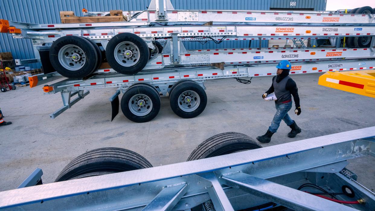 Melvin Harrison checks on intermodal container chassis trailers he is stacking for shipment at Stoughton Trailers in Stoughton. Stoughton Trailers prevailed in their complaint that China was selling trailers in the United States for below their actual cost.