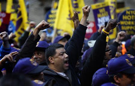 Members of the Service Employees International Union (SEIU) chant slogans during a protest in support of a new contract for apartment building workers in New York City, April 2, 2014. REUTERS/Mike Segar