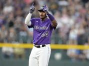 Colorado Rockies' Elehuris Montero gestures to the dugout after hitting a double that drove in two runs off Arizona Diamondbacks starting pitcher Zach Davies in the fourth inning of a baseball game Friday, Aug. 12, 2022, in Denver. (AP Photo/David Zalubowski)