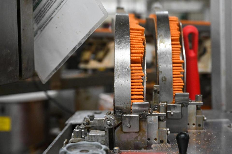 Lance cheese crackers make their way through the quarter-mile automated line before getting peanut butter filling Nov. 8, 2023, at Campbell’s Snacks plant in Charlotte.