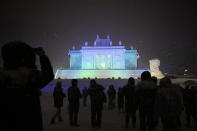 Tourists gather in front of a large snow sculpture of Poland's Palace on the Isle during the annual Sapporo Snow Festival at Odori Park in Sapporo, Hokkaido, Japan, Feb. 5, 2020. (AP Photo/Jae C. Hong)