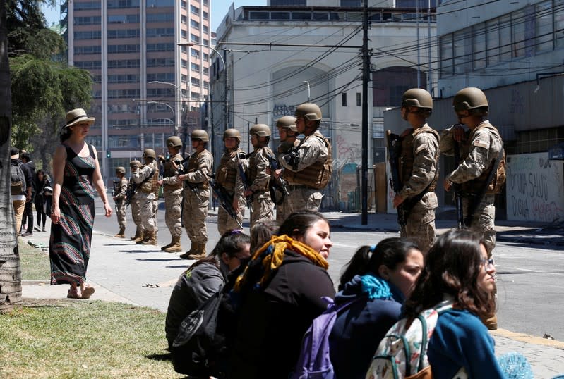 Soldiers patrol the street one day after a protest against the government in Valparaiso