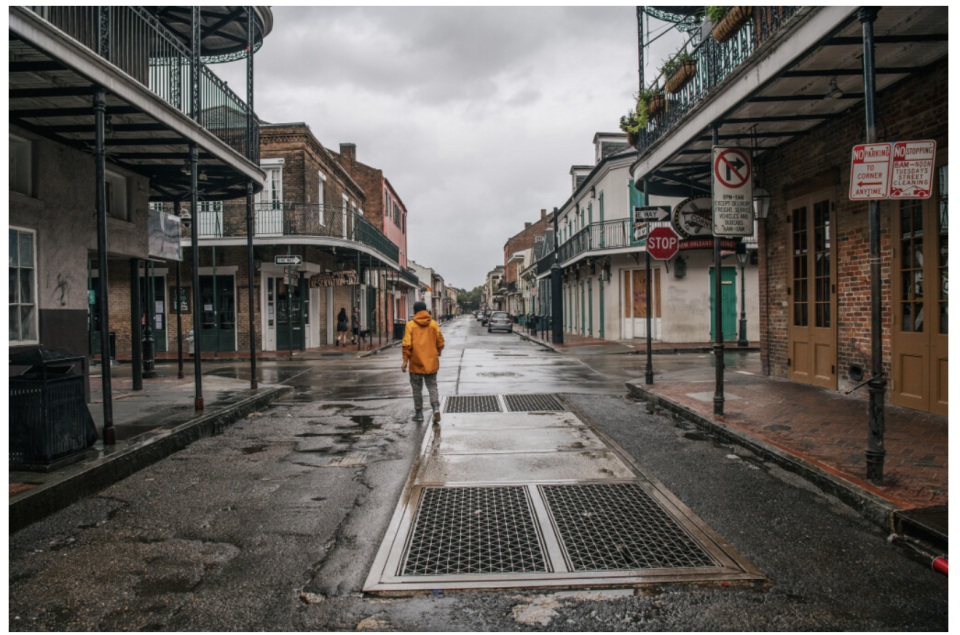 A person walks through New Orleans' French Quarter ahead of Hurricane Ida. Residents of New Orleans prepare as the outer bands of the hurricane begin to cut across the city.