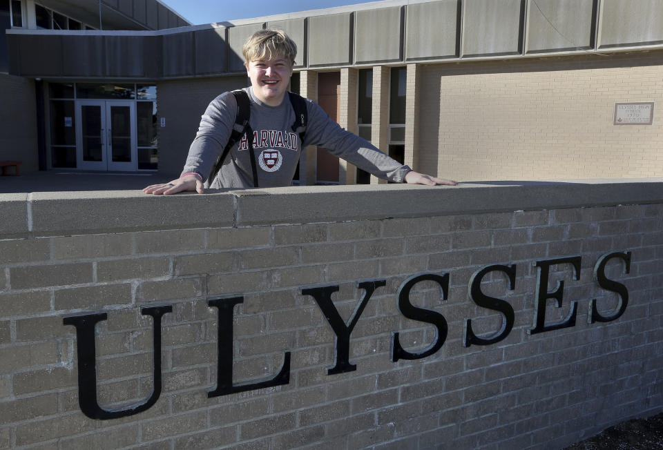 Ulysses High School senior Braxton Moral stands for a portrait outside the school in Ulysses, Kan., on Wednesday, Dec. 12, 2018. The 16-year old said his fellow students here often treat him just like any other student, although they do like to tease him about his expected graduation from Harvard University a few weeks before he graduates from high school. (Sandra J. Milburn/The Hutchinson News via AP)