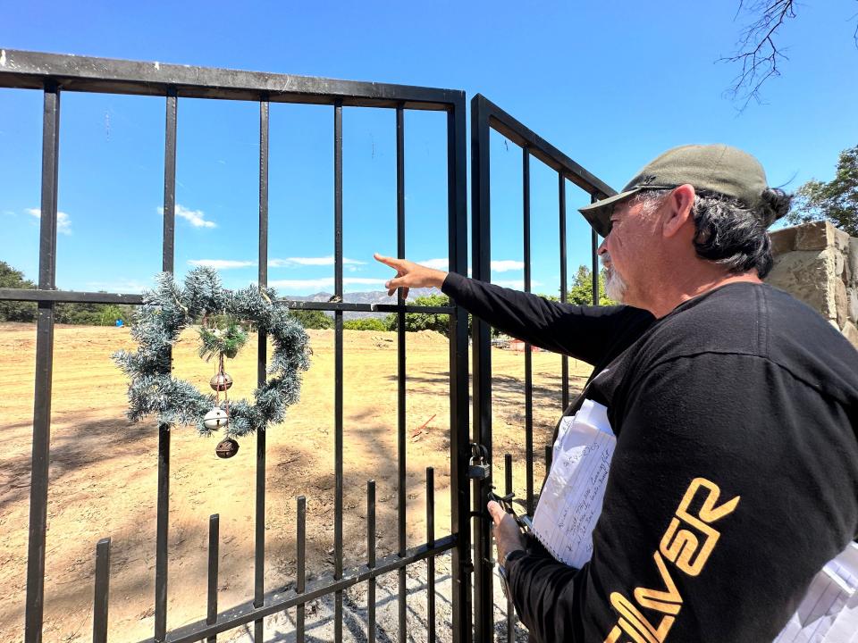 Michael Chapman points out the area where his great-grandmother is buried at St. Thomas Aquinas Cemetery outside Ojai on Sept. 8. Crews are now sifting dirt before resuming a construction project halted last month due to community concerns.