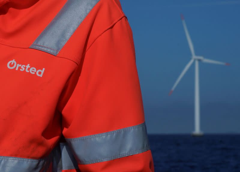FILE PHOTO: The logo for Orsted can be seen on the jacket worn by an employee at Orsted's offshore wind farm near Nysted