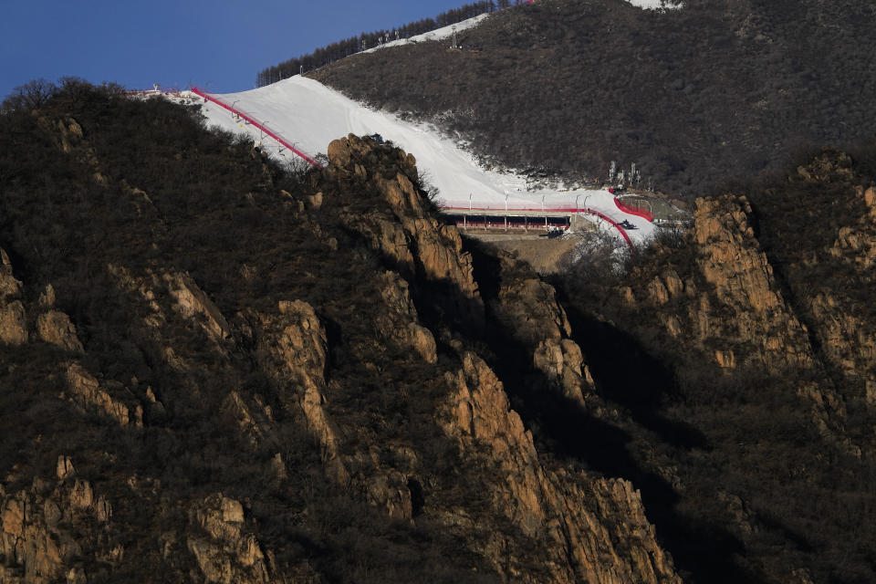 FILE - A ski slope at the National Alpine Ski Center, a venue for alpine skiing at the 2022 Winter Olympics, is pictured from the Yanqing National Sliding Center on Jan. 28, 2022, in the Yanqing district of Beijing. Olympic athletes in Alpine skiing and other outdoor sports dependent on snow are worried as they see winters disappearing. (AP Photo/Jae C. Hong, File)