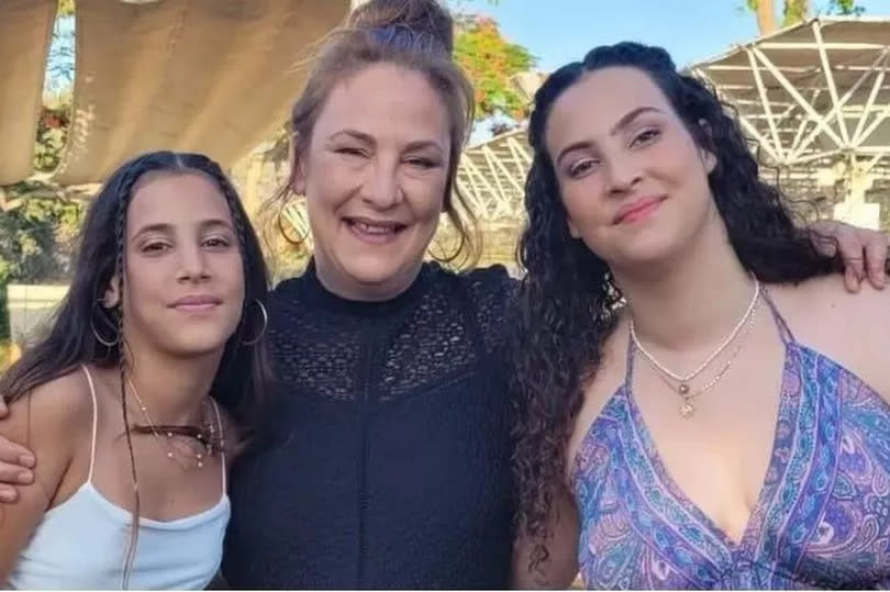 Lianne and her daughters in an old photo, smiling and looking towards camera