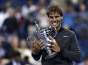 Rafael Nadal of Spain poses with his trophy after defeating Novak Djokovic of Serbia in their men's final match at the U.S. Open tennis championships in New York, September 9, 2013.
