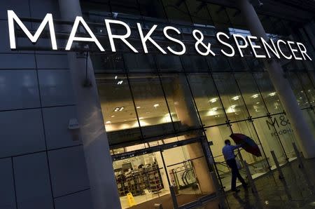 A man leaves a Marks & Spencer store in London, Britain in this January 7, 2016 file photo. REUTERS/Toby Melville/Files