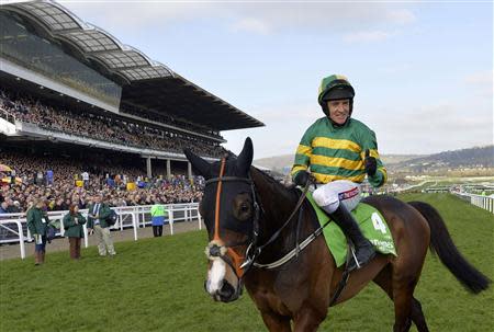 Jockey Barry Geraghty riding Jezki celebrates winning the Champion Hurdle Challenge Trophy at the Cheltenham Festival horse racing meet in Gloucestershire, western England March 11, 2014. REUTERS/Toby Melville