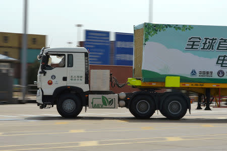 An autonomous electric truck jointly developed by Tianjin Port, Sinotruck and TrunkTech moves a container during a trial operation at a port in Tianjin, China April 12, 2018. Picture taken April 12, 2018. REUTERS/Stringer