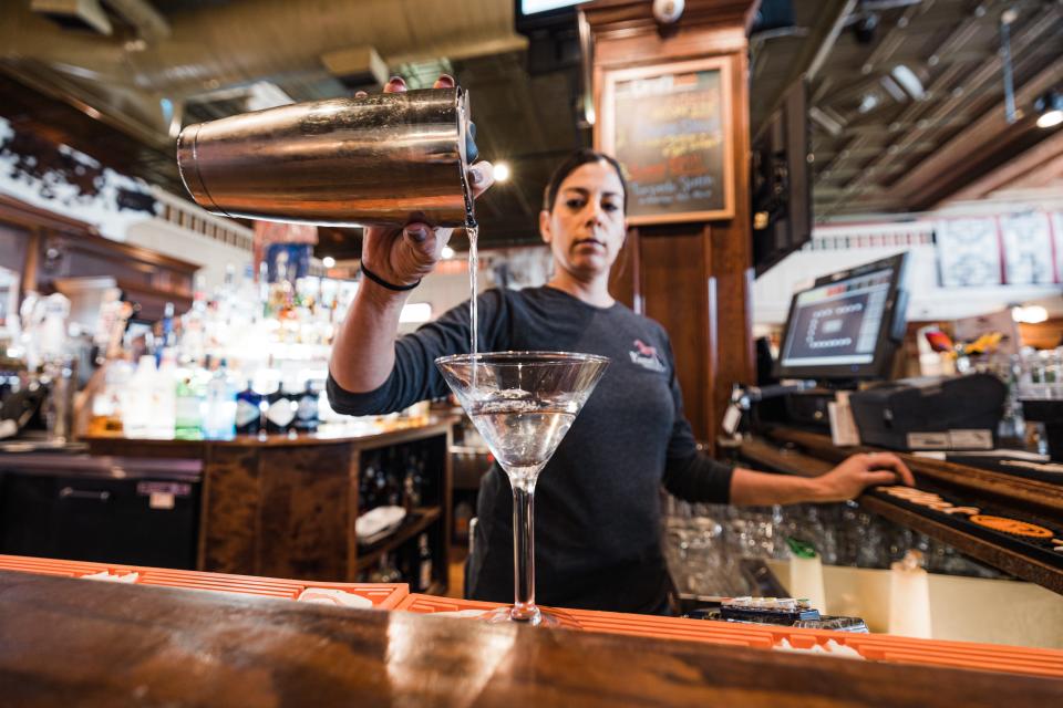 Bartender Lisa Macias pours a drink for a customer at the Painted Horse located in downtown Bartlesville.