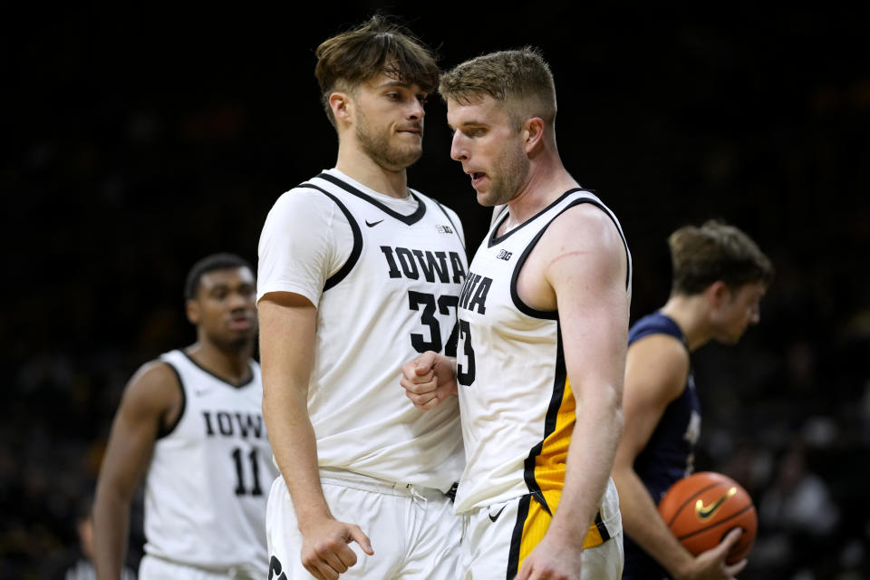 Iowa forward Ben Krikke celebrates with teammate forward Owen Freeman (32) after making a basket during the second half of an NCAA college basketball game against North Florida, Wednesday, Nov. 29, 2023, in Iowa City, Iowa. (AP Photo/Charlie Neibergall)