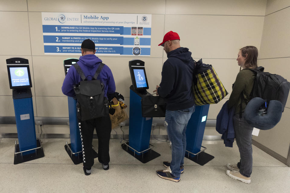 International travelers not using the Mobile Passport Control app, stop and use the portal to get their initial processing and instructions on their next procedure, in the port of entry at Washington Dulles International Airport in Chantilly, Va. Monday, April 1, 2024. A Mobile Passport Control app user can bypass this procedure and go straight to a Custom Border Protection officer for processing easing their way to the port of entry. (AP Photo/Manuel Balce Ceneta)