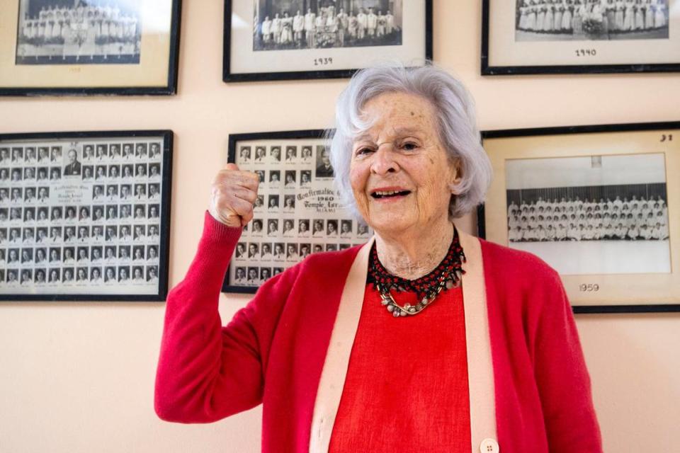 Ruth Greenfield, pictured at 98, points to her 1939 Confirmation Class photo at Temple Israel of Greater Miami on Friday, March 11, 2022.