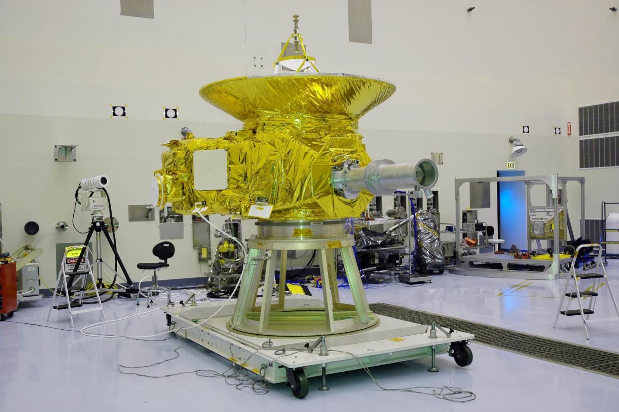 KENNEDY SPACE CENTER, FLA. - In NASA Kennedy Space Center’s Payload Hazardous Servicing Facility, the New Horizons spacecraft sits on a work stand prior to being moved to a spin table.  The spacecraft will undergo a spin test as part of prelaunch processing.  New Horizons is expected to be launched in January 2006 on a journey to Pluto and its moon, Charon.  It is expected to reach Pluto in July 2015.