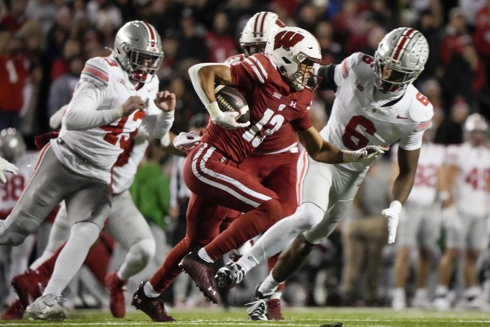 Wisconsin wide receiver Chimere Dike (13) runs after a catch during the first half of an NCAA college football game against Ohio State Saturday, Oct. 28, 2023, in Madison, Wis. (AP Photo/Morry Gash)