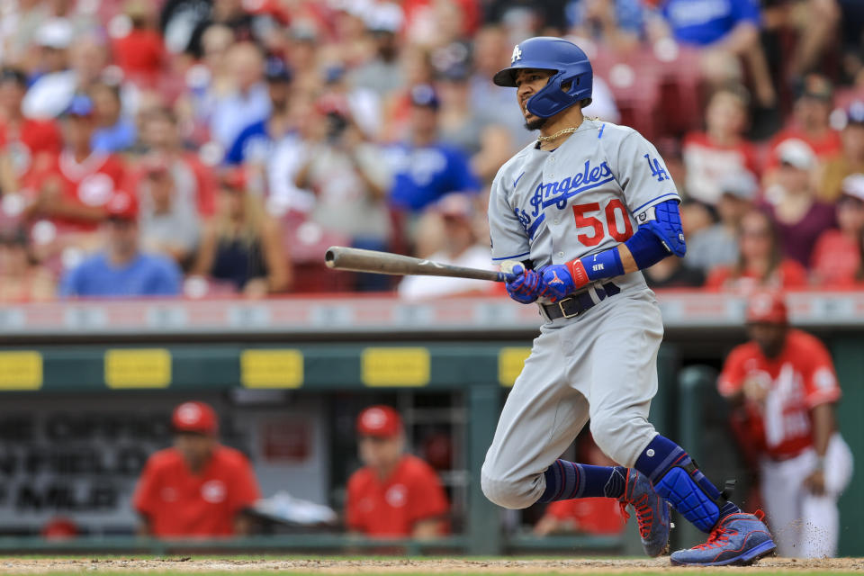 Los Angeles Dodgers' Mookie Betts hits an RBI-single during the ninth inning of a baseball game against the Cincinnati Reds in Cincinnati, Saturday, Sept. 18, 2021. (AP Photo/Aaron Doster)