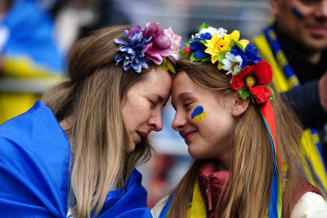 Ukraine fans share an emotional moment in the stands ahead of their country's World Cup qualifying play-off final against Wales in June in Cardiff. The sporting world showed solidarity with Ukraine in the aftermath of the Russian invasion. Wales clinched the spot in Qatar after a Gareth Bale goal earned a 1-0 win