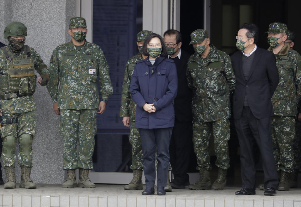 Taiwan's President Tsai Ing-wen, center, inspects the Penghu Magong military base in outlying Penghu Island, Taiwan, Friday, Dec. 30, 2022. Taiwan President Tsai thanked the men and women serving in the navy and army Friday for holding up the island's defense, after China sent a record-breaking number of warplanes and ships towards the island this week. (AP Photo/ Chiang Ying-ying)