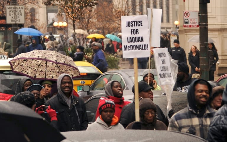 Protesters march on Chicago's Magnificent Mile shopping strip during the Black Friday shopping day on November 27, 2015 demanding justice for a black teen killed by a police officer