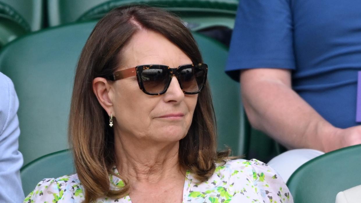  Carole Middleton wears sunglasses and a floral dress as she watches the tennis at Wimbledon on Day 10 in 2024. 