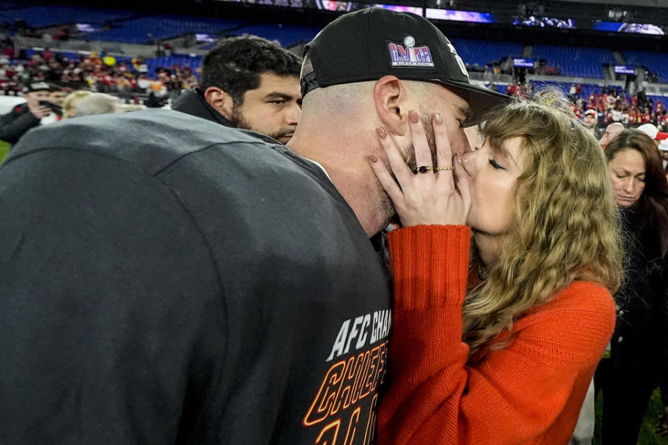 Taylor Swift kisses Kansas City’s Travis Kelce after the Chiefs beat the Baltimore Ravens to advance to Super Bowl LVIII.<span class="copyright">Julio Cortez—AP</span>