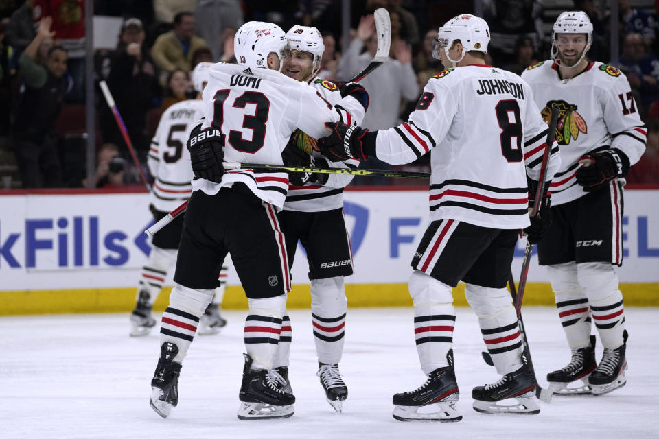 Chicago Blackhawks center Max Domi, left, hugs right wing Patrick Kane after Kane's hat trick during the second period of the team's NHL hockey game against the Toronto Maple Leafs on Sunday, Feb. 19, 2023, in Chicago. The goal was initially waved off before being declared good. (AP Photo/Erin Hooley)