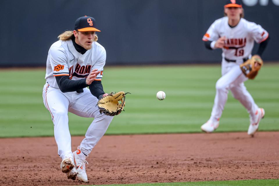 Oklahoma State infielder Aidan Meola (2) fields a ground ball and throws to first during a college baseball game between the Oklahoma State Cowboys (OSU) and the Loyola Marymount University Lions (LMU) at O’Brate Stadium in Stillwater, Okla., on Saturday, Feb. 25, 2023.