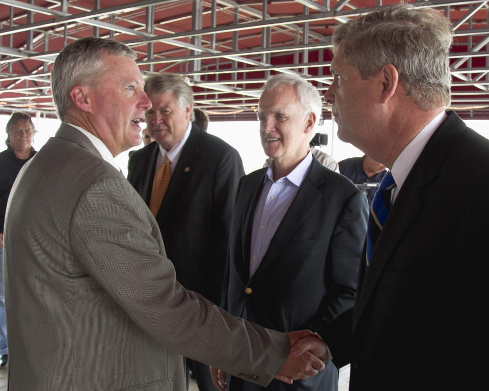 Secretary of Agriculture Tom Vilsack, right, shakes the hand of ethanol producer Duane Kristensen of Chief Ethanol Fuels in Hastings, Neb., left, as democratic senate candidate Bob Kerrey, center, looks on, following a meeting with agriculture producers in Omaha, Neb., Friday, Aug. 10, 2012. The federal government on Friday slashed its expectations for U.S. corn and soybean production for the second month in a row as the worst drought in decades continues punishing key farm states. (AP Photo/Nati Harnik)