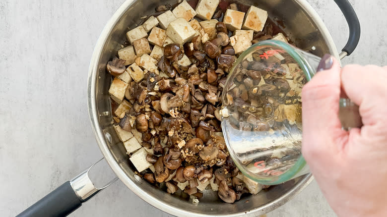 pouring sauce into skillet