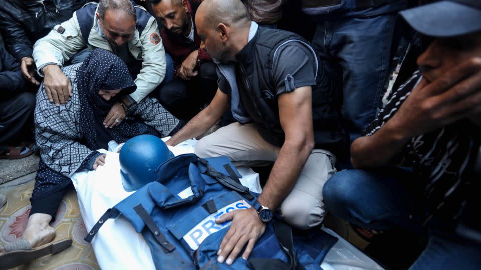 Mourners gather around the body of Al Jazeera cameraman Abu Daqqa on Saturday. - Ahmad Hasaballah/Getty Images