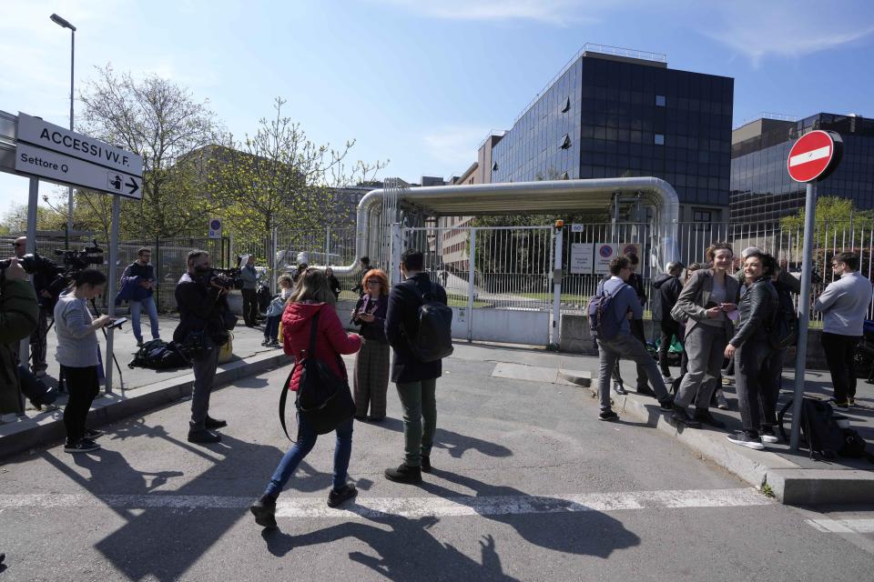 Reporters wait outside the San Raffaele hospital, in Milan, Italy, Wednesday, April 5, 2023. Ex-Premier Silvio Berlusconi was hospitalized Wednesday with apparent respiratory problems, Italian media reported. The 86-year-old three-time premier was in intensive care at Milan's San Raffaele hospital, the clinic where he routinely receives care, LaPresse news agency, Sky TG24 and Corriere della Sera reported, without citing sources.(AP Photo/Luca Bruno)