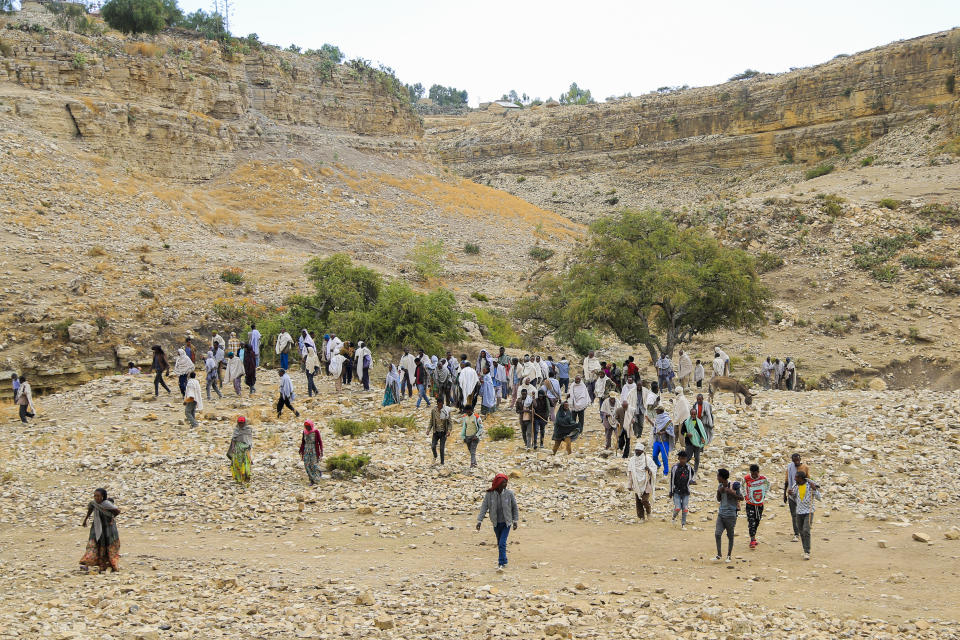 Farmers and villagers walk back home after mediating a row between two brothers in Mai Mekden, in the Tigray region of northern Ethiopia, on Tuesday, Feb. 27, 2024. (AP Photo/Tesfalem Girmay Assefa)